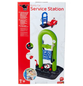 Spielzeug-Autowerkstatt im Karton mit grünem Bogen, blauem Schild und rotem Auto auf der Verpackung.