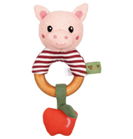 Eine Babyrassel mit Plüsch-Schweinekopf, Holzring und rotem Apfelstoff am unteren Ende.