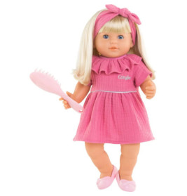Blonde Puppe im rosa Kleid mit Haarband, hält eine rosa Bürste und trägt rosa Schuhe.