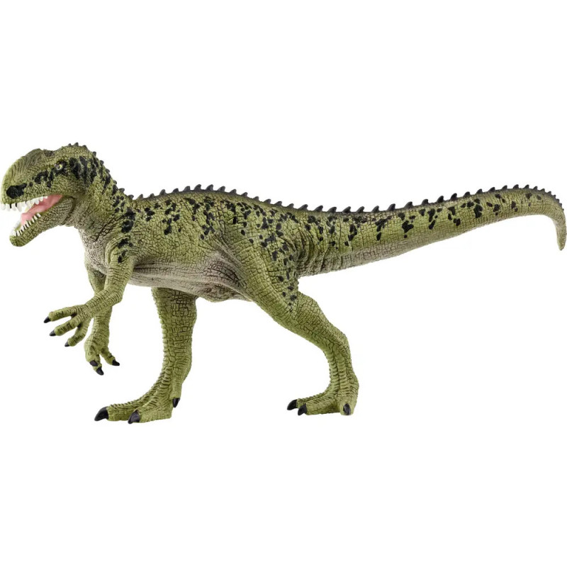 Grünes Dinosaurier-Spielzeug mit schwarzen Flecken, steht auf zwei Beinen und hat das Maul geöffnet. Grünes Dinosaurier-Spielzeug mit schwarzen Flecken, steht auf zwei Beinen und hat das Maul geöffnet.