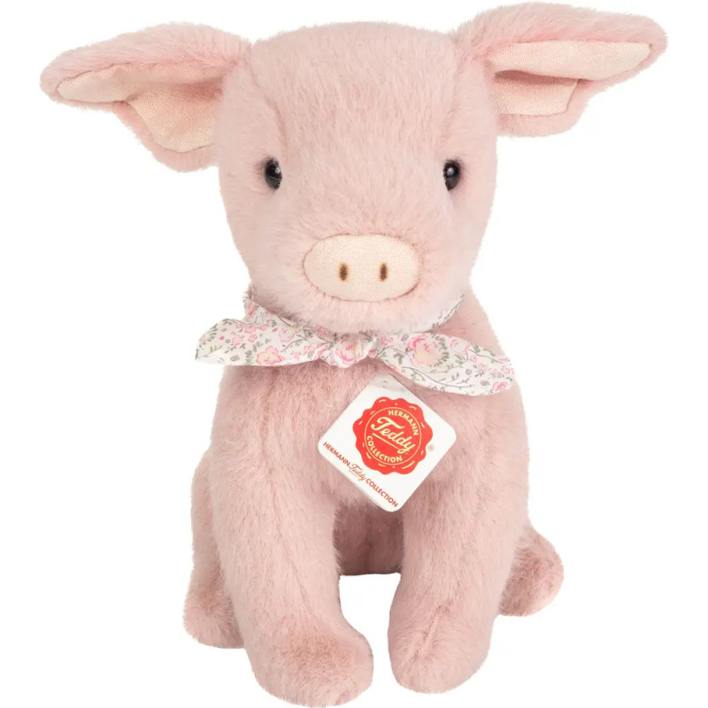 Rosa Plüschschwein mit geblümtem Schal um den Hals und einem Etikett an der Brust.
