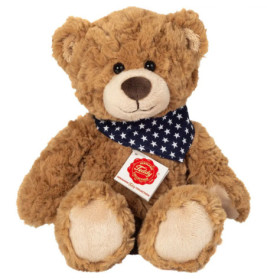 Brauner Teddybär mit blauem Halstuch und weißen Sternen sowie rotem Etikett auf der Brust.