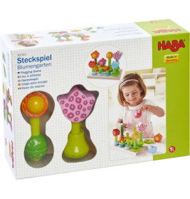 HABA Steckspiel Flower Garden: Bunte Holzblumen im Karton, ein Mädchen spielt mit dem Set.