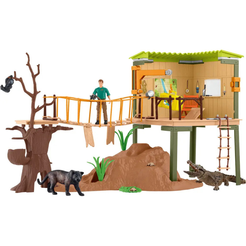Dschungel-Baumhaus-Spielset mit Brücke, Spielfigur, Tieren, Bäumen und Pflanzen vor weißem Hintergrund.