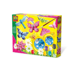 Bastelset mit Schmetterlings- und Libellenmotiven, Farben, Pinseln, Glitzer auf gelbem Blumenhintergrund.