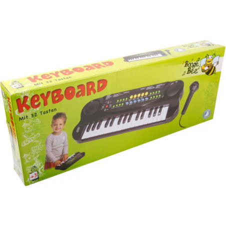 Grüne Box mit Spielzeug-Keyboard und Mikrofon, abgebildetes spielendes Kind. Marke: Boogie Bee. Ab 3 Jahren.
