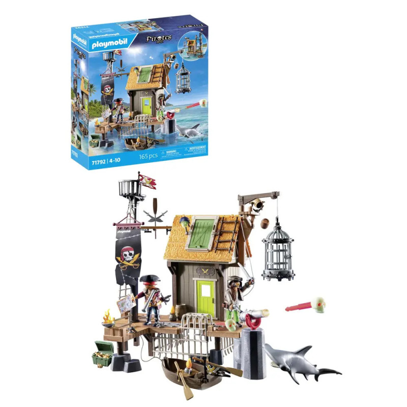 Playmobil Piratenset mit Hütte, Figuren, Zubehör und Hai Verpackung im Hintergrund sichtbar.