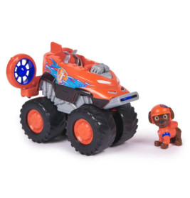 Oranger Spielzeug-Monstertruck mit blauen Mustern neben einer kleinen Hundefigur mit Helm und Weste.