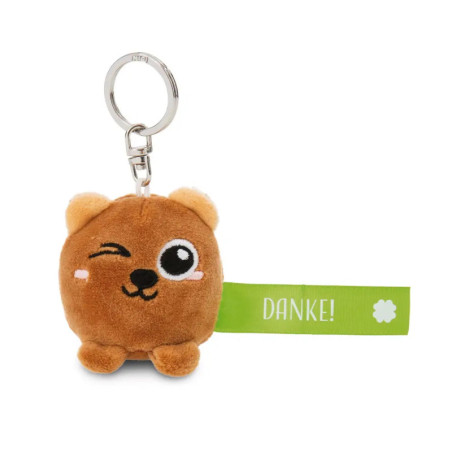 Schlüsselanhänger: Plüschbär zwinkert, grünes DANKE! -Schild und Pfotenabdruck.