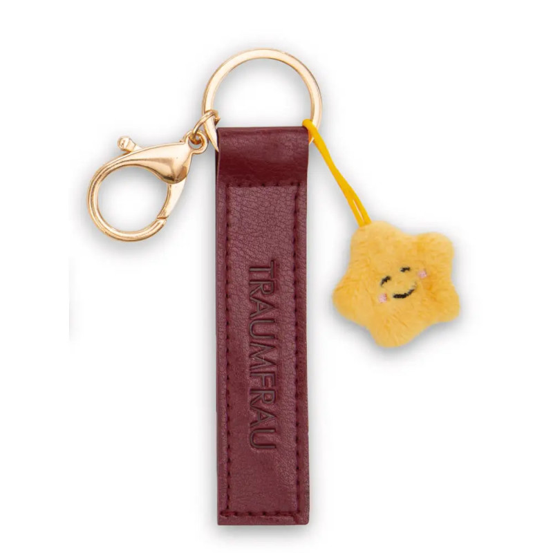 Schlüsselanhänger mit bordeauxrotem Lederanhänger, goldener Öse und kleinem gelbem Plüschstern mit Gesicht.
