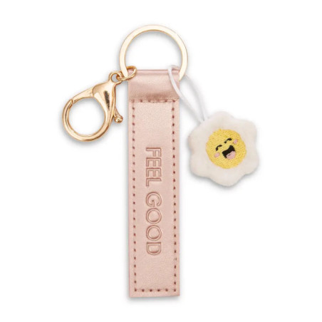 Rosa Schlüsselanhänger mit FEEL GOOD-Schriftzug und kleinem, lächelnden Ei-Anhänger.
