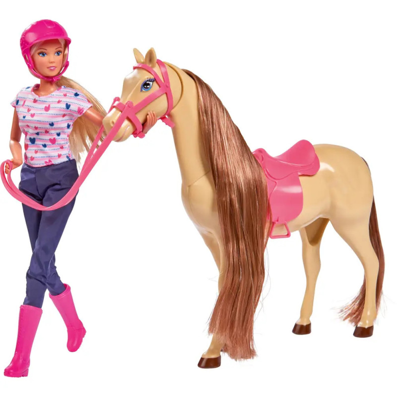 Barbie-Puppe in Reitkleidung hält die Zügel eines beigefarbenen Pferdes mit pinkem Sattel und Zaumzeug.