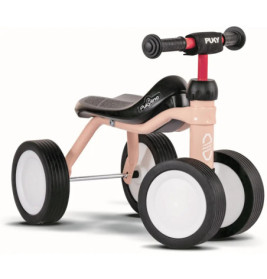 Kleine rosa-schwarze Lauflernräder für Kleinkinder mit vier Gummireifen, ohne Pedale.