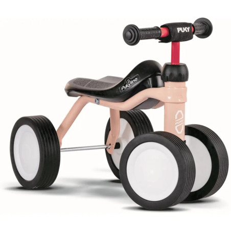 Kleine rosa-schwarze Lauflernräder für Kleinkinder mit vier Gummireifen, ohne Pedale.