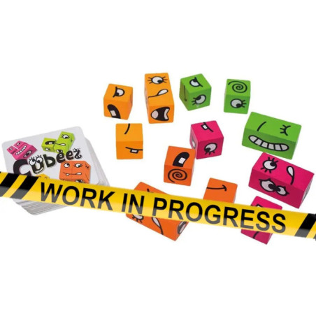 Bunte Würfel mit Gesichtern, Karten und einem WORK IN PROGRESS-Band im Bild.