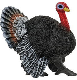 Plastik-Truthahnfigur mit schwarzer, weißer und roter Bemalung vor weißem Hintergrund.