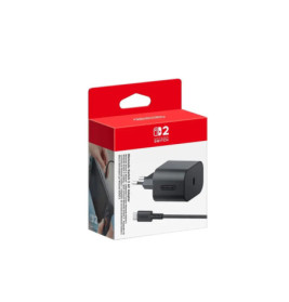 Schwarzes Nintendo Switch Netzteil in rot-weißer Verpackung.