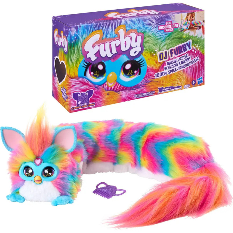 Bunter Furby mit großen Augen und langem Schwanz, abgebildet mit Verpackung und lilafarbener Bürste.