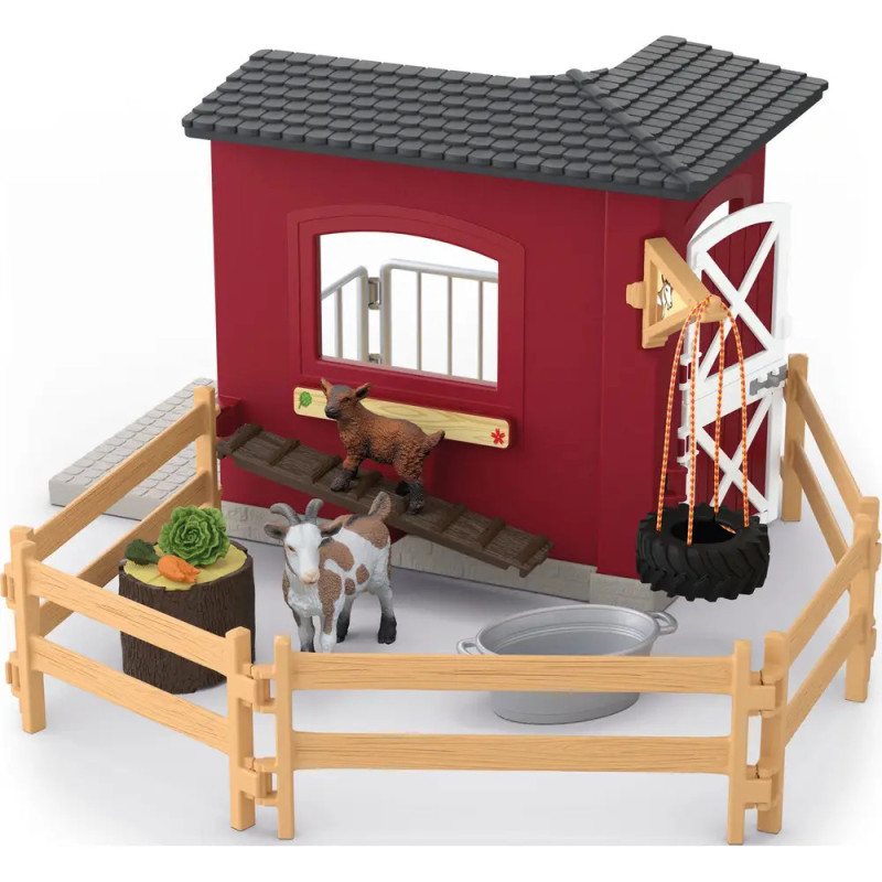 Spielzeug-Bauernhof mit Zaun, Ziege, Zicklein, Futtertrog, Eimer und Windmühle auf einer Seite. Spielzeug-Bauernhof mit Zaun, Ziege, Zicklein, Futtertrog, Eimer und Windmühle auf einer Seite.