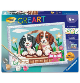 Malkasten mit zwei Welpen im Korb, Farbtöpfen, Pinsel und Blumenmotiv auf dem Deckel.