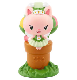 Rosa Cartoon-Katzenfigur im grünen Kleid sitzt auf braunem Topf mit Pfotenabdruck, bunter Ball dahinter.