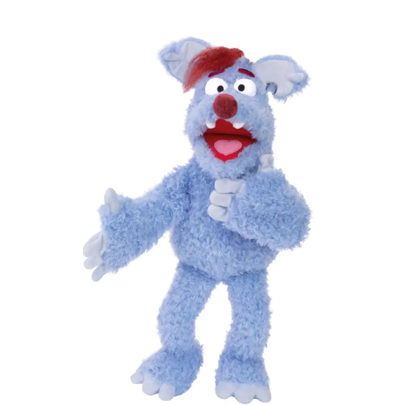 Eine blaue, zottelige Puppe mit roten Haaren und großer Nase hebt einen Arm.