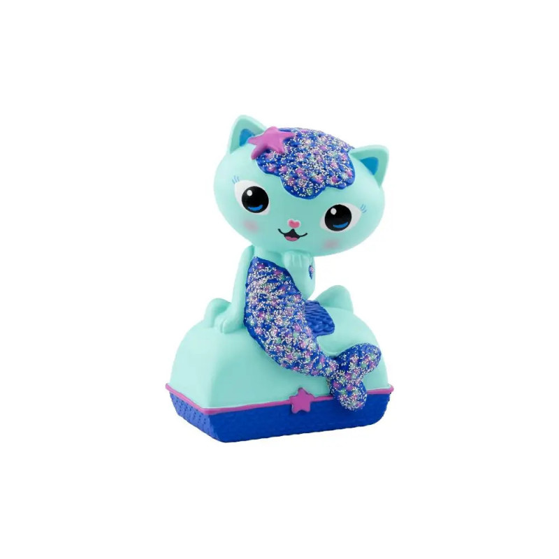 Ein blaues Katzen-Nixen-Spielzeug mit glitzernden lila Akzenten sitzt auf einem rechteckigen Sockel.