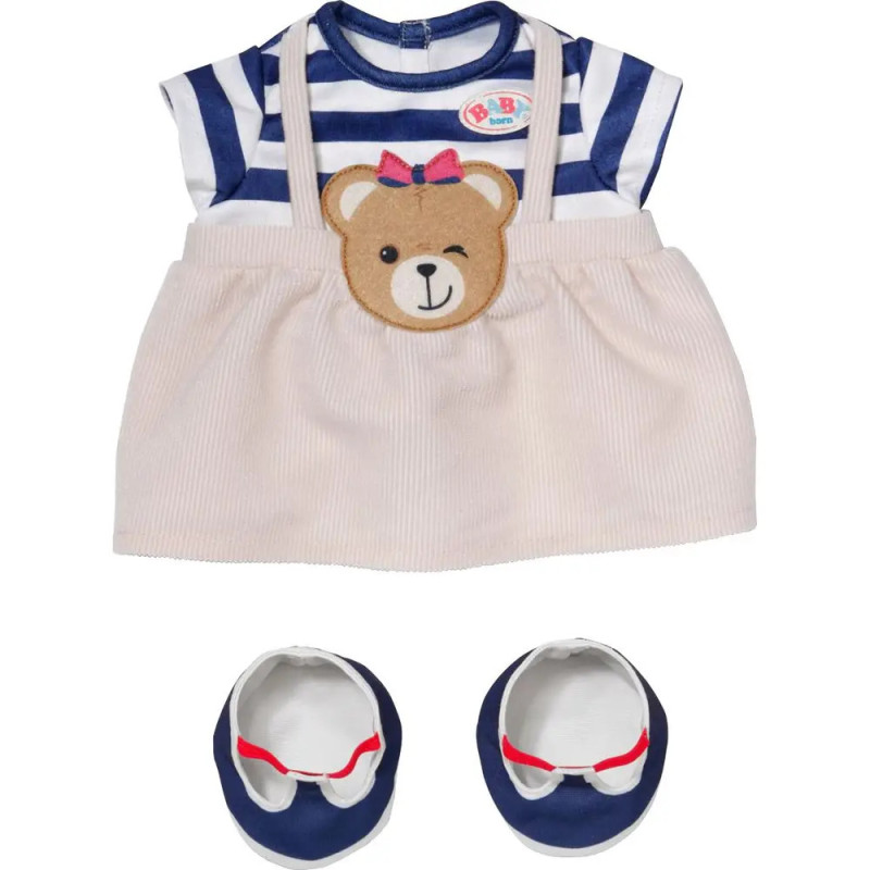 Baby-Outfit mit blau gestreiftem Oberteil, beigefarbenem Bärenrock und passenden blauen Schuhen. Baby-Outfit mit blau gestreiftem Oberteil, beigefarbenem Bärenrock und passenden blauen Schuhen.