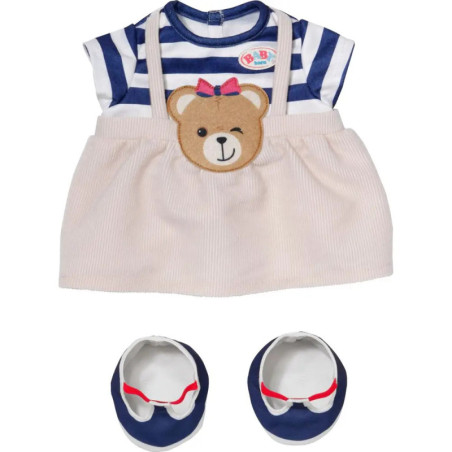 Baby-Outfit mit blau gestreiftem Oberteil, beigefarbenem Bärenrock und passenden blauen Schuhen. Baby-Outfit mit blau gestreiftem Oberteil, beigefarbenem Bärenrock und passenden blauen Schuhen.