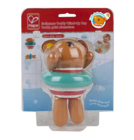 Aufziehbarer Schwimmer-Teddy mit türkisem Schwimmreifen in Verpackung, geeignet ab 12 Monaten.