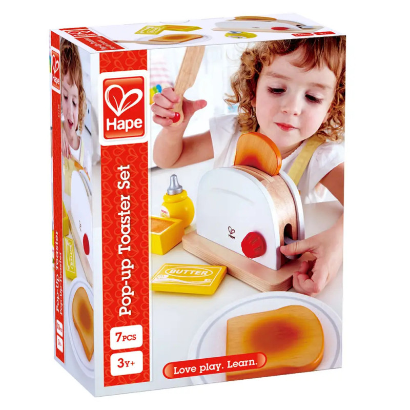 Kind spielt mit Hape Pop-up Toaster-Set, bestehend aus Toaster, Brotscheiben, Butter und Zubehör. Kind spielt mit Hape Pop-up Toaster-Set, bestehend aus Toaster, Brotscheiben, Butter und Zubehör.